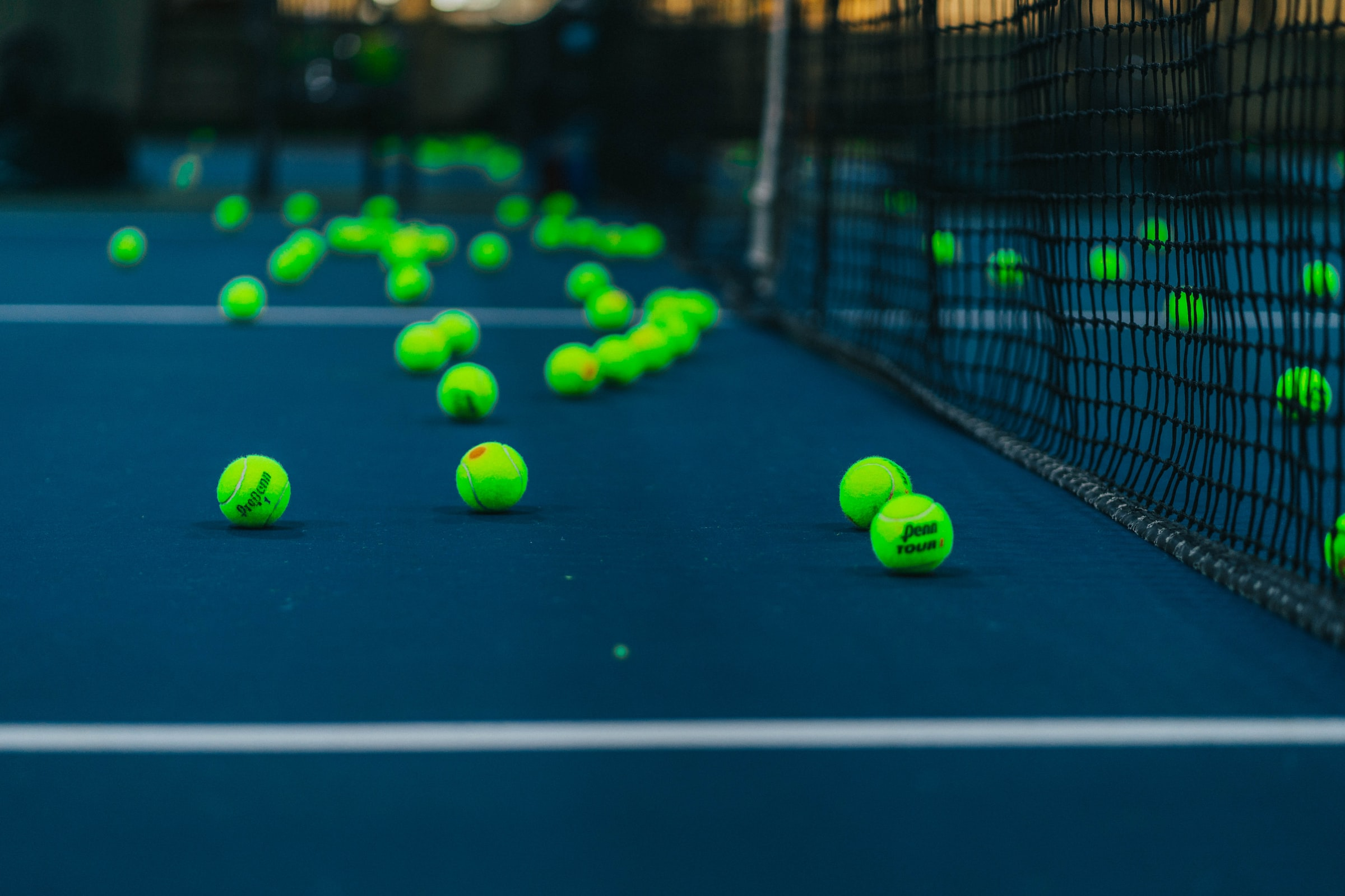 Image of Tennis court and net with tennis balls